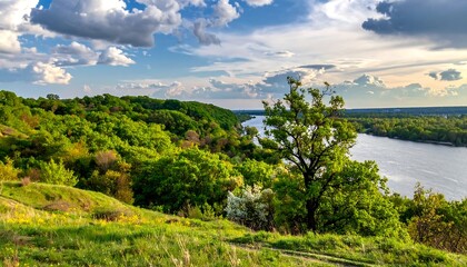 River vista Lush hills meet a wide river under a partly cloudy sky at golden hour in nature's embrace