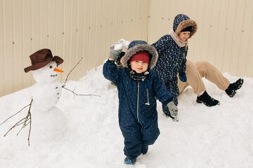 Children having fun playing outdoor in winter snow