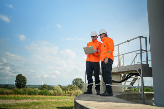 Construction workers collaborate on renewable energy project wind farm site professional photo outdoor wide angle sustainability