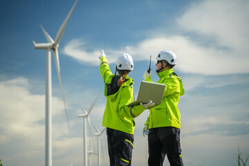 Wind energy inspection team evaluating turbines remote location professional photography clear skies overhead view renewable concept © Surachai