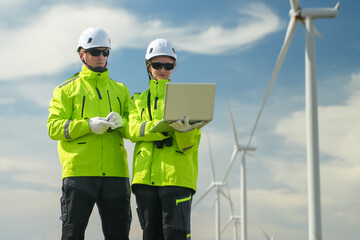 Wind energy technicians analyzing data wind farm professional image outdoor close-up renewable energy insights