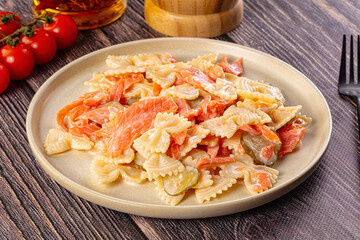 Italian pasta farfalle with salmon