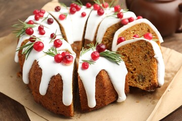 Tasty Christmas cake with cranberries on wooden table, closeup