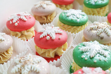 Festively decorated macarons in box, closeup. Christmas treat