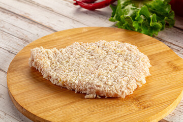 Raw breaded schnitzel for roast