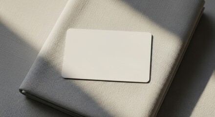 Minimalist Business Card Mockup on Textured Surface with Sunlight.