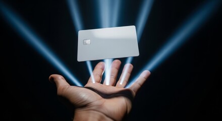 Credit Card Floating Above Hand with Blue Light Rays.