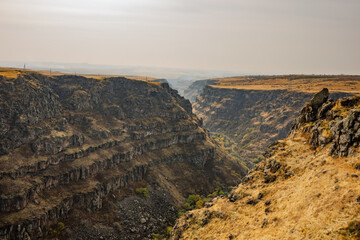 A rocky canyon with a river running through it
