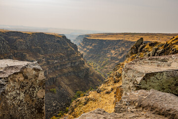 A rocky canyon with a river running through it