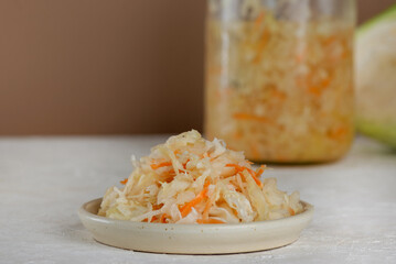 Fermented white cabbage or sauerkraut in a plate. Probiotic food.
