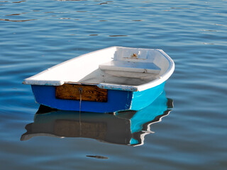 Skiff Rowboat Reflected in Calm Harbour Waters