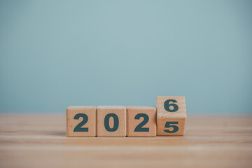 Wooden cube blocks for the transition from 2025 to 2026. Countdown to 2026. Load year from 2025 to 2026. New year start concept.