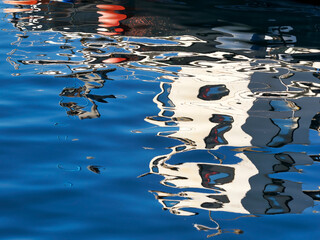 Abstract Boat Reflections in Calm Harbour Waters
