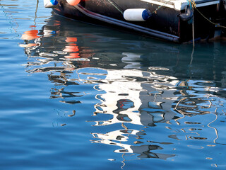Abstract Boat Reflections in Calm Harbour Waters
