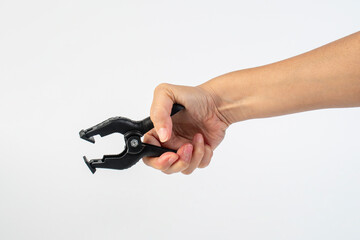 Fototapeta premium A studio shot of a black plastic spring clamp in hand isolated on a white background
