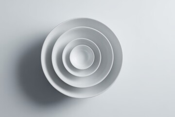 Fototapeta premium Minimalist White Bowls - Concentric Circles of Ceramic Simplicity on a Clean Background.