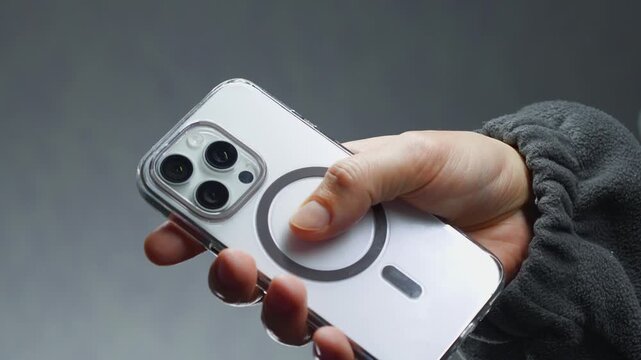 A person holding a white mobile phone with a camera.
Lens on the back of the smartphone.
Photo taken with a phone and a modern camera with zoom on the phone.
Lens, smartphone, phone, mobile