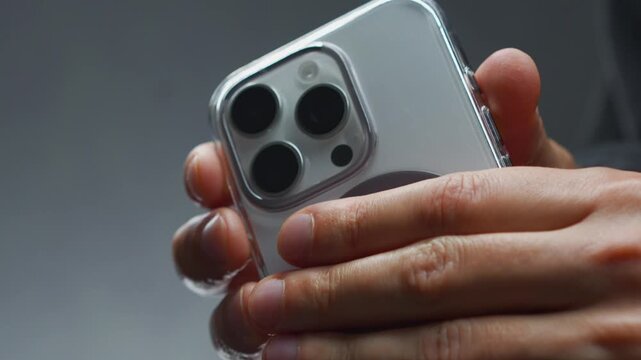 A person holding a white mobile phone with a camera.
Lens on the back of the smartphone.
Photo taken with a phone and a modern camera with zoom on the phone.
Lens, smartphone, phone, mobile