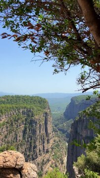 A mountain valley landscape with forests and cliffs. Huge rocks and rocky outcrops. A beautiful deep canyon with lots of tourists. A bird's-eye view of the Tasi Canyon. T&uuml;rkiye