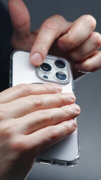 A person holding a white mobile phone with a camera.
Lens on the back of the smartphone.
Photo taken with a phone and a modern camera with zoom on the phone.
Lens, smartphone, phone, mobile