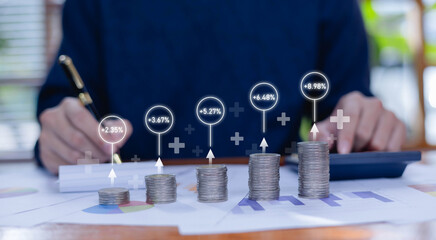 Stacks of coins with rising percentage indicators represent financial growth, investment returns, profit analysis, economic planning as calculates and reviews data in a modern business setting