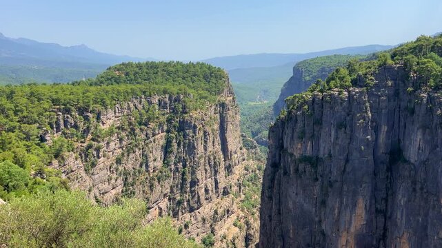 A mountain valley landscape with forests and cliffs. Huge rocks and rocky outcrops. A beautiful deep canyon with lots of tourists. A bird's-eye view of the Tasi Canyon. T&uuml;rkiye