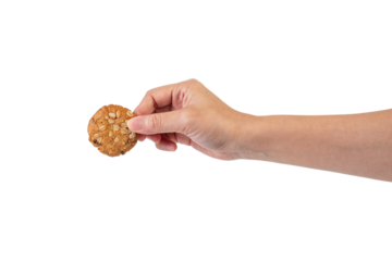 Cookies sprinkled with grains in hand on transparent background