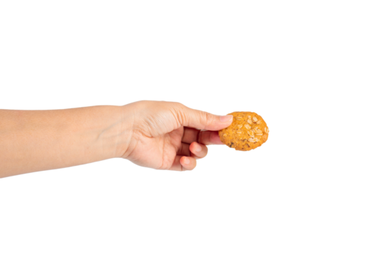 Cookies sprinkled with grains in hand on transparent background