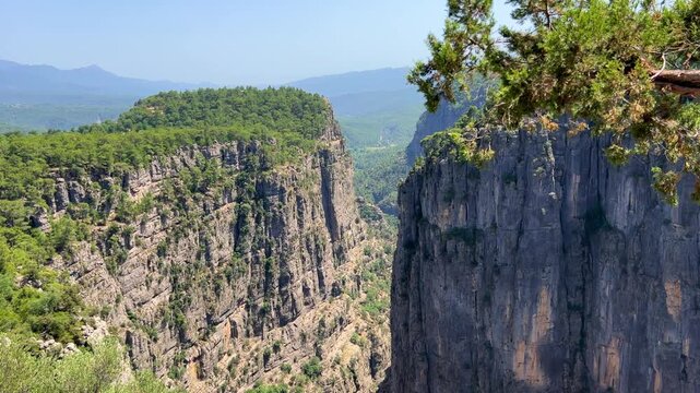 A mountain valley landscape with forests and cliffs. Huge rocks and rocky outcrops. A beautiful deep canyon with lots of tourists. A bird's-eye view of the Tasi Canyon. T&uuml;rkiye
