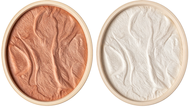 Two round beige palettes with textured powder, one tan and one white