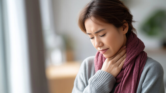 Faceless seasonal sickness young Asian woman defocused indoor background feeling throat pain cold and inflammation winter illness respiratory discomfort seasonal health