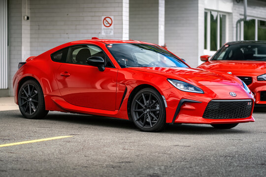 Brno, Czech Republic - October 10, 2025: Red Toyota GR86 sports car parked outside in front of a garage. Small fast Japanese car for driving pleasure.