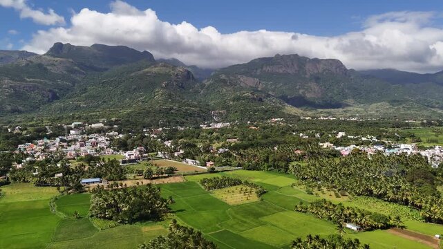 Breathtaking drone shot of Courtallam, Tamil Nadu &mdash; where misty mountains, green forests, and waterfalls create a serene blend of nature and town life.