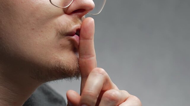 Shh gesture.
Parken shows a close-up of the silence gesture.
Silence and stillness.
Keeping secrets.
Talking, whispering, secret, finger, not making noise.