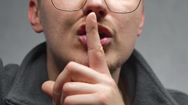 Shh gesture.
Parken shows a close-up of the silence gesture.
Silence and stillness.
Keeping secrets.
Talking, whispering, secret, finger, not making noise.