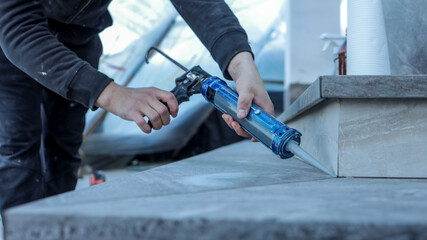 Applying sealant to a countertop during a home renovation project