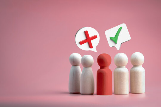 Group of wooden doll with check mark and cross. Right and wrong concept. checklists, approval lists, and academic test.