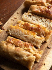 focaccia breadsticks on wooden board