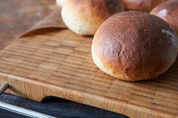 Bread buns on a cutting board. Selective focus.