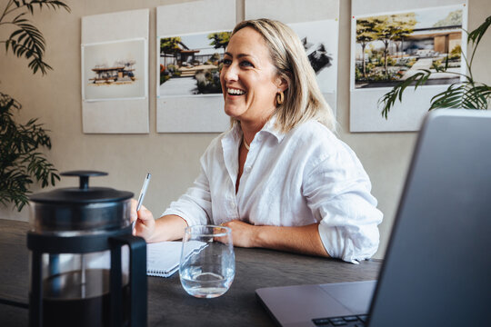Professional woman working in an architecture studio with modern decor - Powered by Adobe