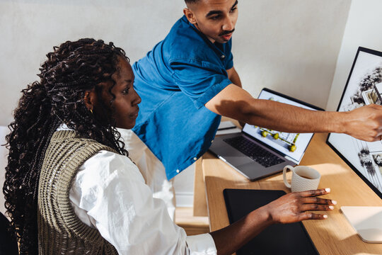Young professionals discussing architectural designs in a modern office environment