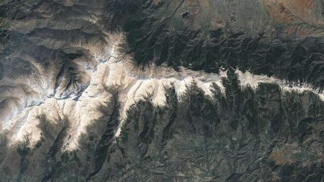 Panoramic shot on mountain ridge covered with snow. Camera is zooming in, rotating clockwise. Animation based on image by NASA