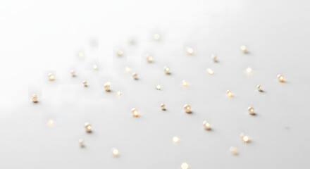 Radiant burst of light creating a diagonal lens flare with a shimmering prismatic rainbow spectrum and sparkling particles on a soft gray background