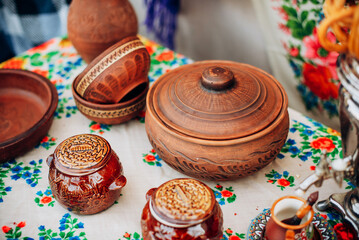 Ukrainian clay tableware on embroidered tablecloth