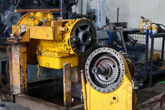 Heavy-duty allison transmission assembly and final drive unit disassembled for maintenance in a professional industrial workshop setting.