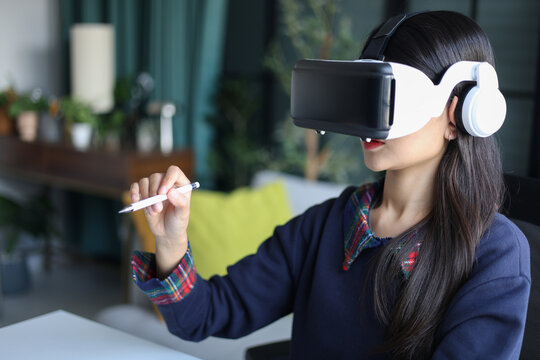 Women wear VR headsets at work for virtual collaboration, designing 3D models, immersive training, and analyzing data in a virtual space. - Powered by Adobe