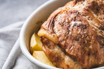 Baked pork with potatoes in baking dish. Top view