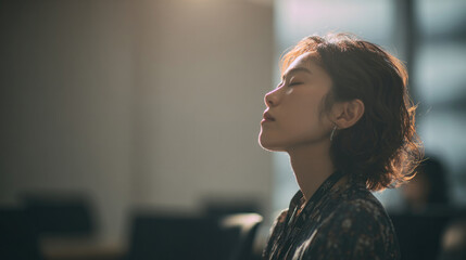 Woman relaxing in natural sunlight with eyes closed