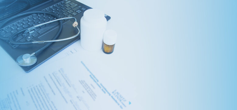 Medical background. A desk with a stethoscope, documents, and a computer. - Powered by Adobe