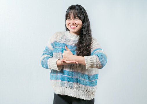 Asian girl gesturing help with hands in nonverbal language. Smiling woman showing help gesture with hands in sign language